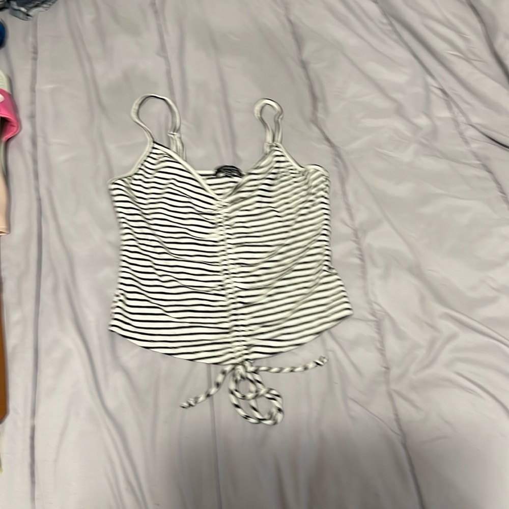 Cute black and white striped tank that ties at the bottom size medium